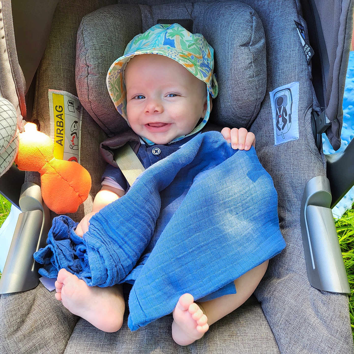 Albert is registered to the contest to win money with this photo: baby, bonnet, cap, car, car_interior, carseat, clothing, cushion, face, hat, head, homedecor, linen, pants, person, photography, portrait, sunhat, transportation, vehicle