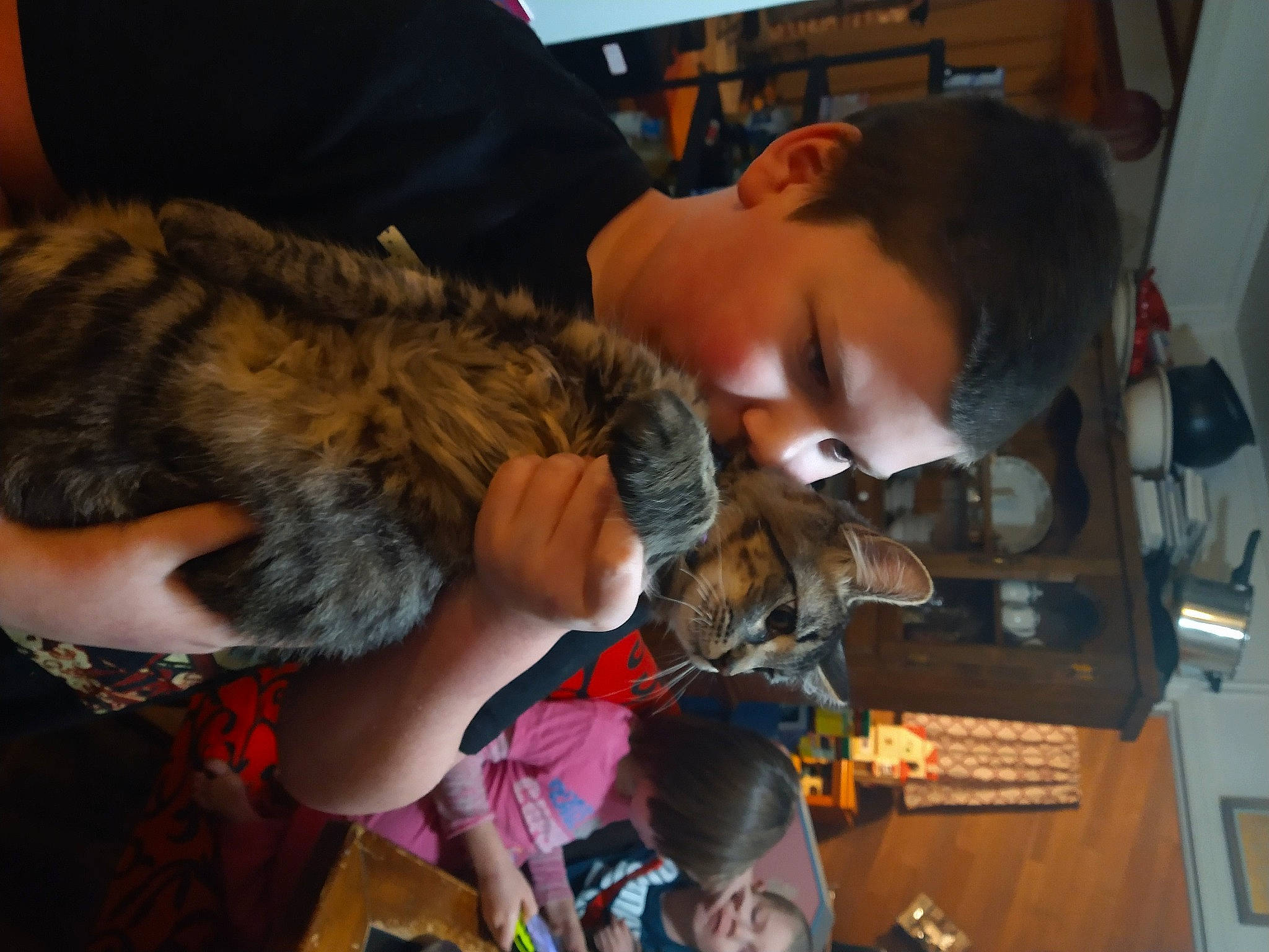 Isaac is registered to the contest to win money with this photo: bird_of_prey, canidae, chair, child, claw, dog_breed, ear, felidae, fun, fur, person, room, small_to_medium_sized_cats, sporting_group, toy, wildlife_biologist