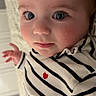 Esmee participe au concours pour gagner de l'argent avec cette photo : baby, child, face, blue_eyes, rosy_cheeks, striped_clothing, heart_symbol, long_eyelashes, close_up, portrait, infant, soft_texture, cozy, lying_down, curious_expression, indoor, cute, person, newborn, casual_wear
