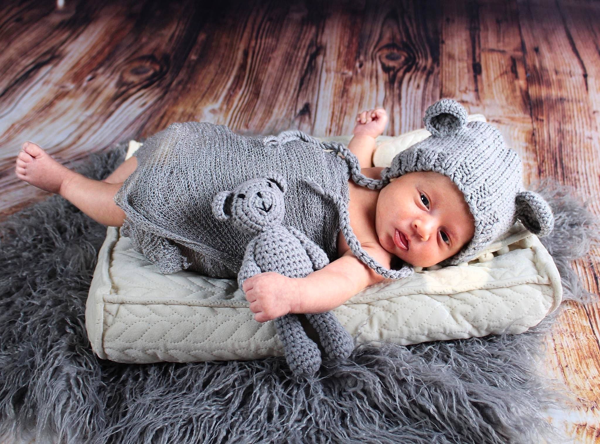Ayden is registered to the contest to win money with this photo: art, baby, baby_toddler_clothing, child, comfort, facial_expression, fashion_accessory, flash_photography, flooring, fun, fur, grass, grey, happy, headwear, linens, person, sitting, skin, textile