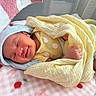 newborn, baby, smiling, blanket, yellow_blanket, blue_hat, sleeping, cozy, pink_blanket, polka_dots, infant, cute, resting, soft_texture, bed, portrait, child, indoors, comfort, peaceful