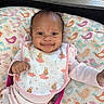 Truly joined the competition — help win amazing prizes! baby, bib, bird_pattern, bunny_print, child, cozy, cushion, cute, face, happy, indoors, infant, lying_down, person, pink_clothing, playpen, portrait, small_fist, smiling, soft_toys