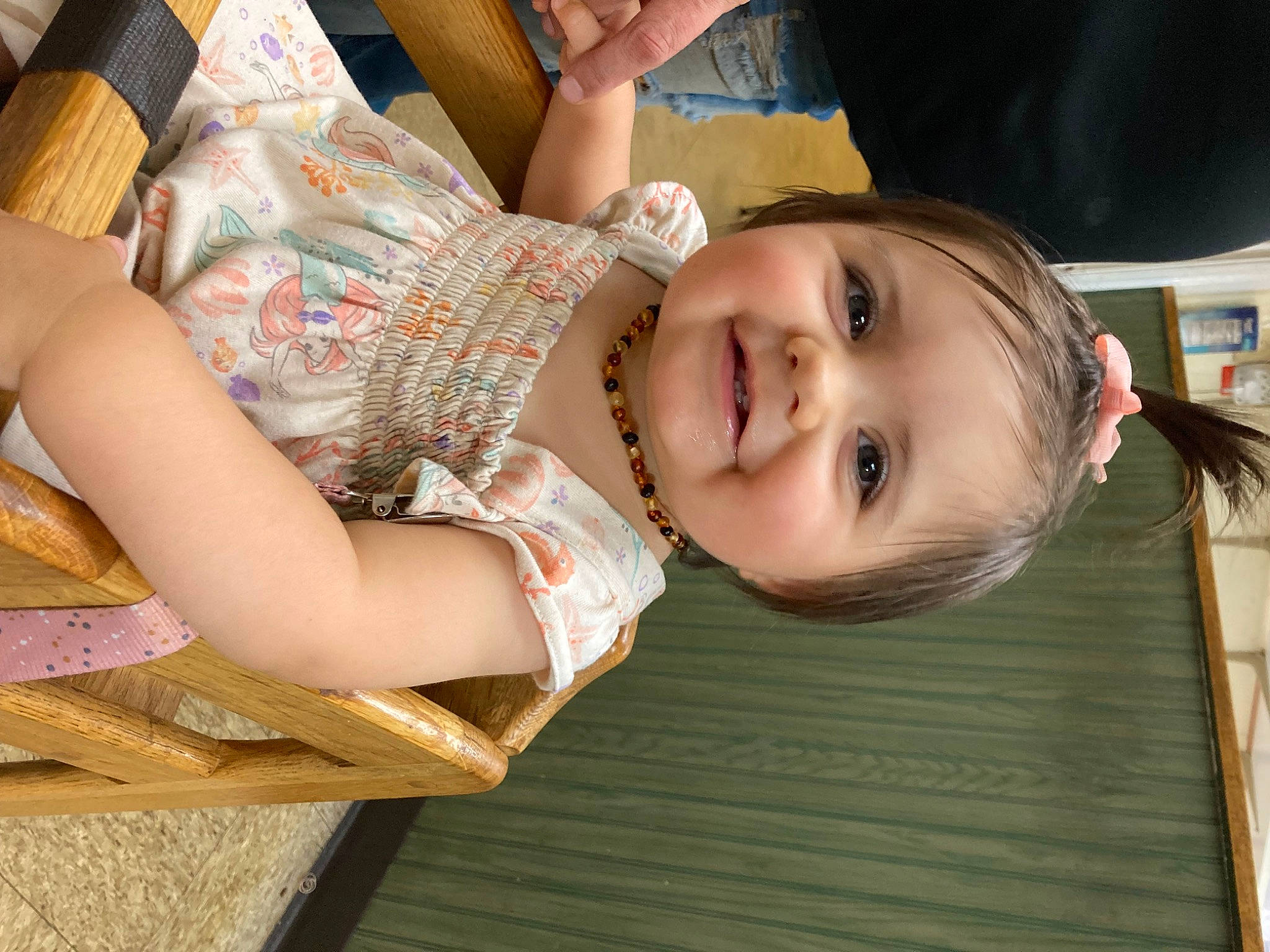 Mariana is registered to the contest to win money with this photo: baby, baby_toddler_clothing, bookcase, cheek, child, finger, fun, happy, human_body, human_leg, iris, joy, leisure, nose, person, shelf, sitting, skin, smile, thigh