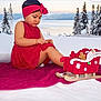 Lëyah participe au concours pour gagner de l'argent avec cette photo : applique, baby, blanket, cap, clothing, dress, face, festival, hat, head, nature, outdoors, pattern, person, photography, plant, portrait, sitting, snow, tree