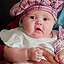 Arianna joined the competition — help win amazing prizes! baby, child, person, face, hat, pink_hat, white_clothing, hands, holding, cute, infant, portrait, indoors, skin, expression, young_child, looking, closeup, wearing, headwear