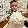 Tessa is registered to the contest to win money with this photo: baby, carpet, child, cozy, cute, drawer, face, furniture, hand, happy, home, indoor, infant, person, plush, polka_dot, smiling, stuffed_animal, toy, wooden_floor