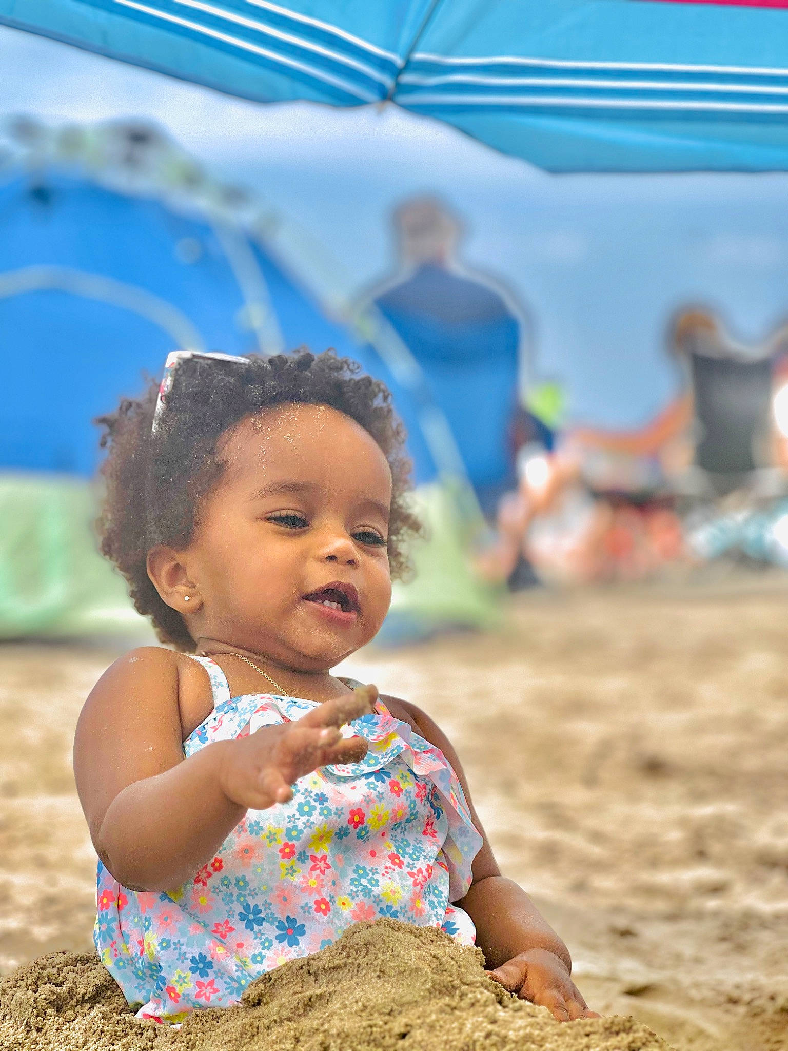 Aaliyah is registered to the contest to win money with this photo: baby_toddler_clothing, blue, child, dress, flash_photography, fun, grass, happy, landscape, leisure, morning, people_in_nature, person, sand, sitting, skin, soil, summer, tent, toddler
