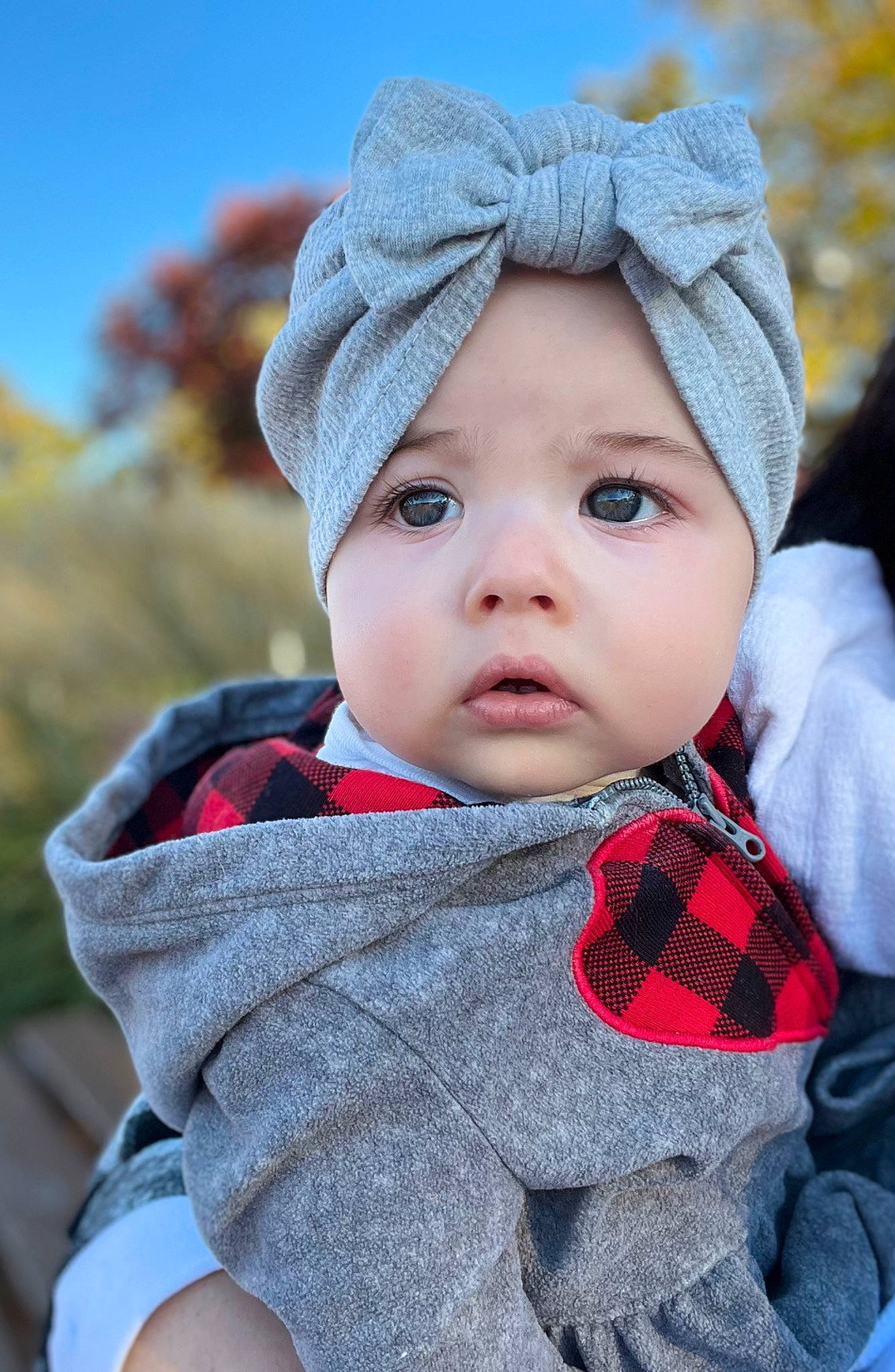Akira is registered to the contest to win money with this photo: baby, baby_toddler_clothing, cap, child, electric_blue, fashion_accessory, grass, happy, headwear, knit_cap, lip, pattern, people_in_nature, person, plaid, skin, sleeve, textile, toddler, tree