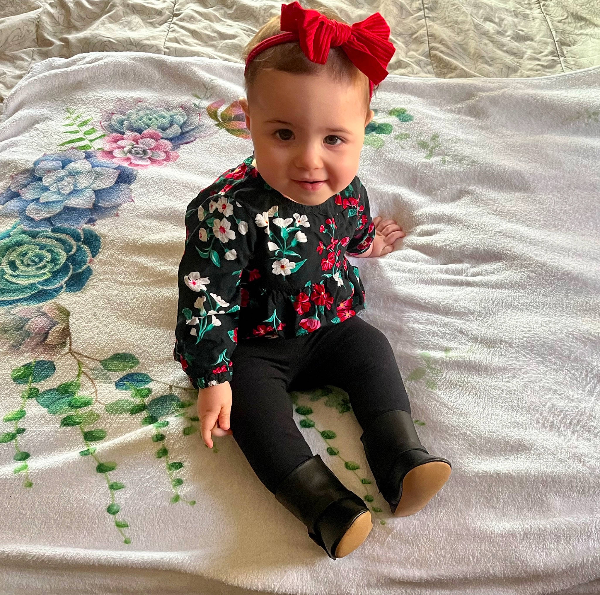 Akira is registered to the contest to win money with this photo: baby, baby_toddler_clothing, child, comfort, face, flooring, happy, hat, head, linens, magenta, pattern, person, sitting, sleeve, smile, sunglasses, t_shirt, textile, toddler