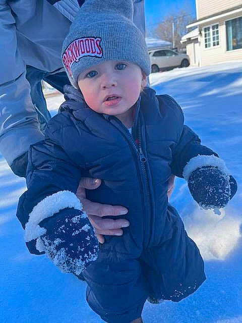 Aydin is registered to the contest to win money with this photo: baby_toddler_clothing, blue, cap, child, electric_blue, freezing, fun, gesture, glove, happy, headwear, outerwear, people_in_nature, person, photograph, plant, recreation, snapshot, snow, toddler