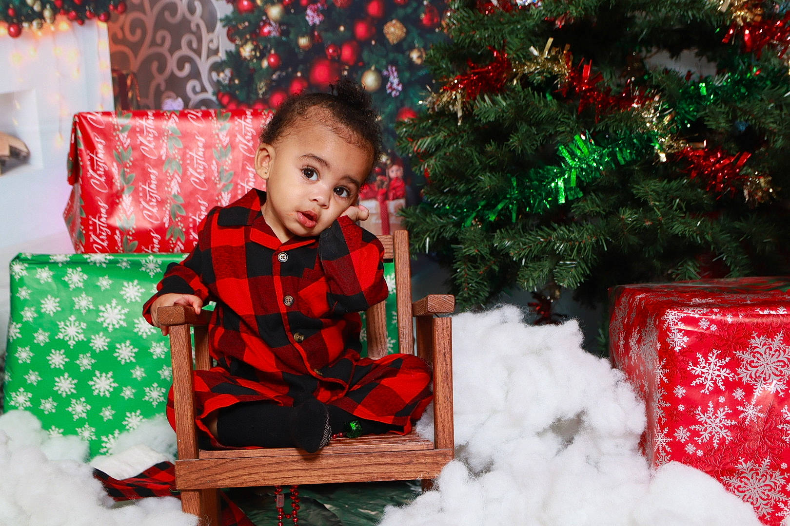 Jaceyon joined the competition — help win amazing prizes! christmas, christmas_decoration, christmas_eve, christmas_ornament, christmas_tree, event, facial_expression, fun, green, happy, holiday, pattern, person, plaid, plant, sitting, snow, surprise, tartan, toddler