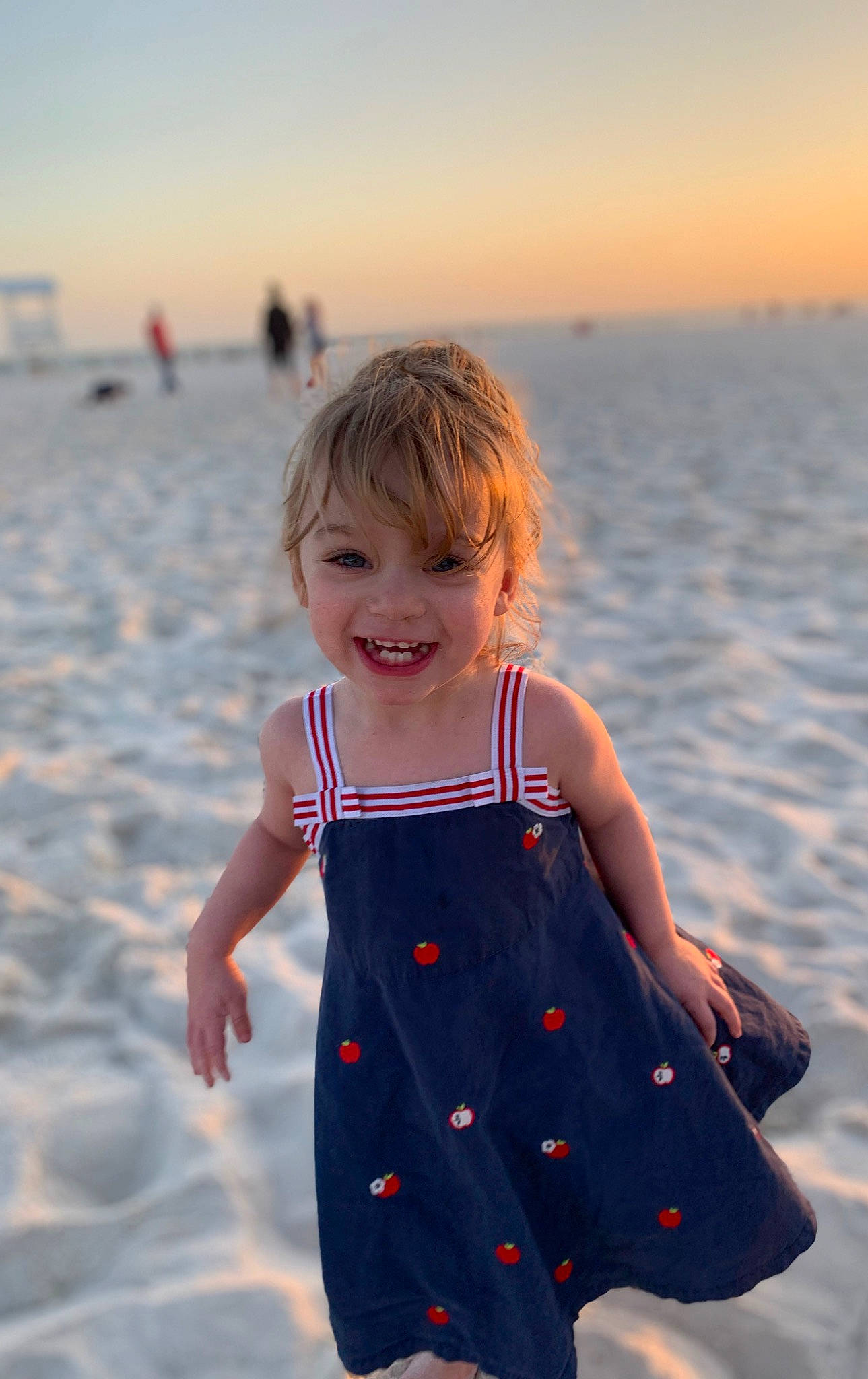 Fallon is registered to the contest to win money with this photo: azure, baby_toddler_clothing, beach, body_of_water, facial_expression, happy, head, joy, one_piece_garment, organ, people_in_nature, people_on_beach, person, photograph, skin, sky, sleeve, smile, standing, sunlight