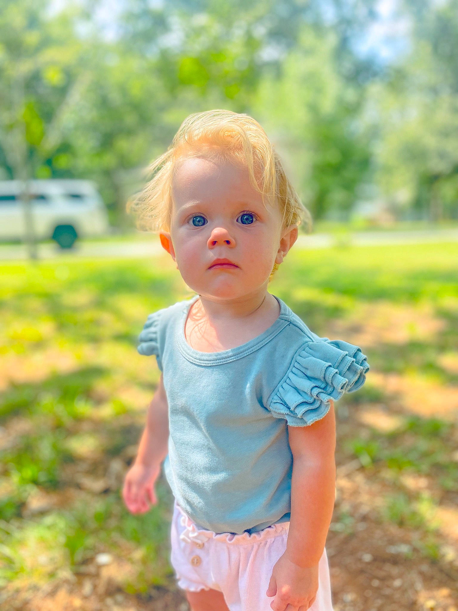 Stella Skye is registered to the contest to win money with this photo: baby_toddler_clothing, blond, child, eye, face, facial_expression, fun, grass, hairstyle, happy, people_in_nature, person, plant, shorts, skin, sleeve, summer, sunlight, t_shirt, toddler
