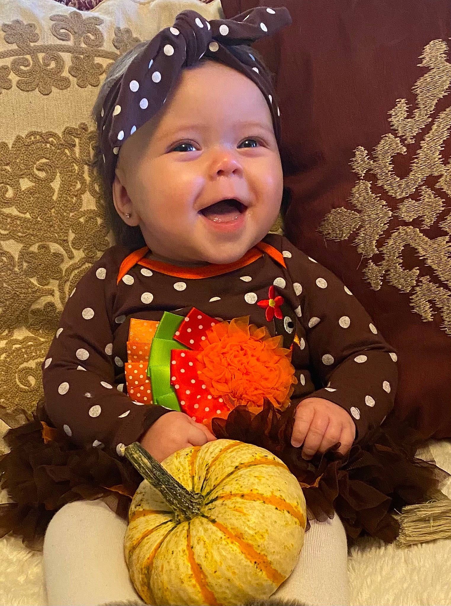Emerie is registered to the contest to win money with this photo: baby, baby_toddler_clothing, calabaza, cucurbita, eye, facial_expression, gourd, happy, head, headwear, human_body, orange, organ, people_in_nature, person, photograph, plant, pumpkin, sleeve, smile