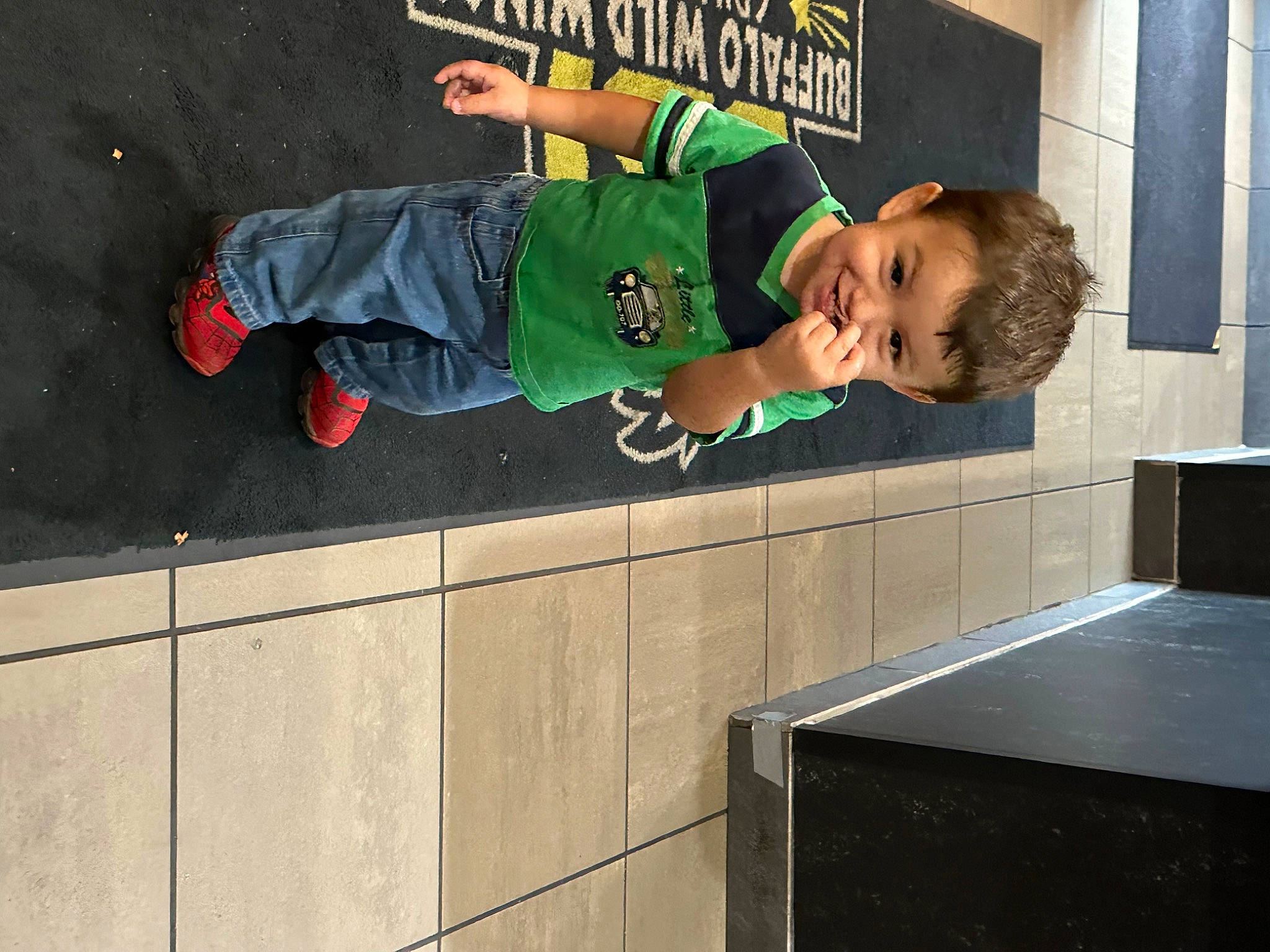 Winston is registered to the contest to win money with this photo: child, composite_material, concrete, cooking, countertop, flooring, fun, happy, joy, kitchen, kitchen_appliance, leisure, logo, person, play, recreation, sleeve, t_shirt, toddler, walking_shoe