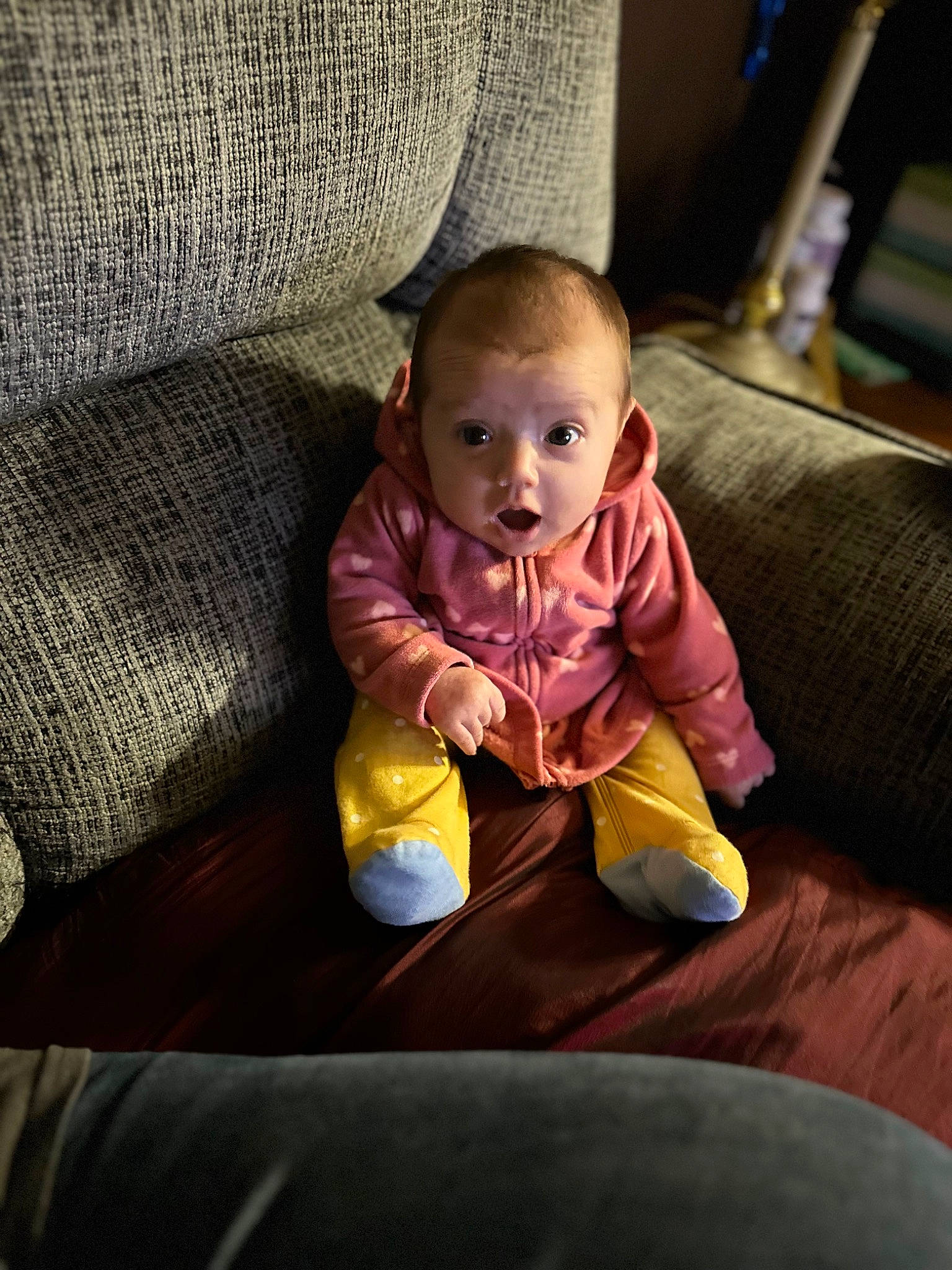 Amberly is registered to the contest to win money with this photo: baby, baby_products, baby_toddler_clothing, car_seat, chair, cheek, child, comfort, couch, eye, flooring, fun, hardwood, linens, person, room, sitting, smile, toddler, wicker