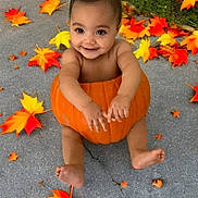 Koda is registered to the contest to win money with this photo: baby, pumpkin, autumn_leaves, fall, outdoor, child, smiling, concrete, seasonal, cute, holiday, nature, orange, yellow, red, barefoot, sitting, festive, happy, portrait