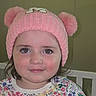 Mia is registered to the contest to win money with this photo: baby, child, clothing, cute, eyes, face, floral_shirt, girl, hat, headwear, indoors, innocent, knit_hat, person, pink_hat, pom_poms, portrait, smile, toddler, young_child