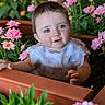 Mia is registered to the contest to win money with this photo: baby, child, flower_bed, pink_flowers, greenery, plant_pot, outdoor, nature, curious, portrait, infant, garden, cute, flora, young_child, face, hands, soft_lighting, colorful, happy