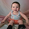 Mia joined the competition — help win amazing prizes! baby, child, smiling, sitting, indoors, clothing, socks, shorts, top, face, cute, happy, portrait, person, skin, head, hair, infant, blanket, soft