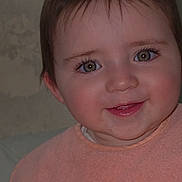Mia is registered to the contest to win money with this photo: baby, child, face, smile, portrait, closeup, infant, cute, eyes, rosy_cheeks, peach_bib, young, adorable, happy, person, skin, hair, indoors, expression, head