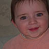 Mia is registered to the contest to win money with this photo: adorable, baby, child, closeup, cute, expression, eyes, face, hair, happy, head, indoors, infant, peach_bib, person, portrait, rosy_cheeks, skin, smile, young