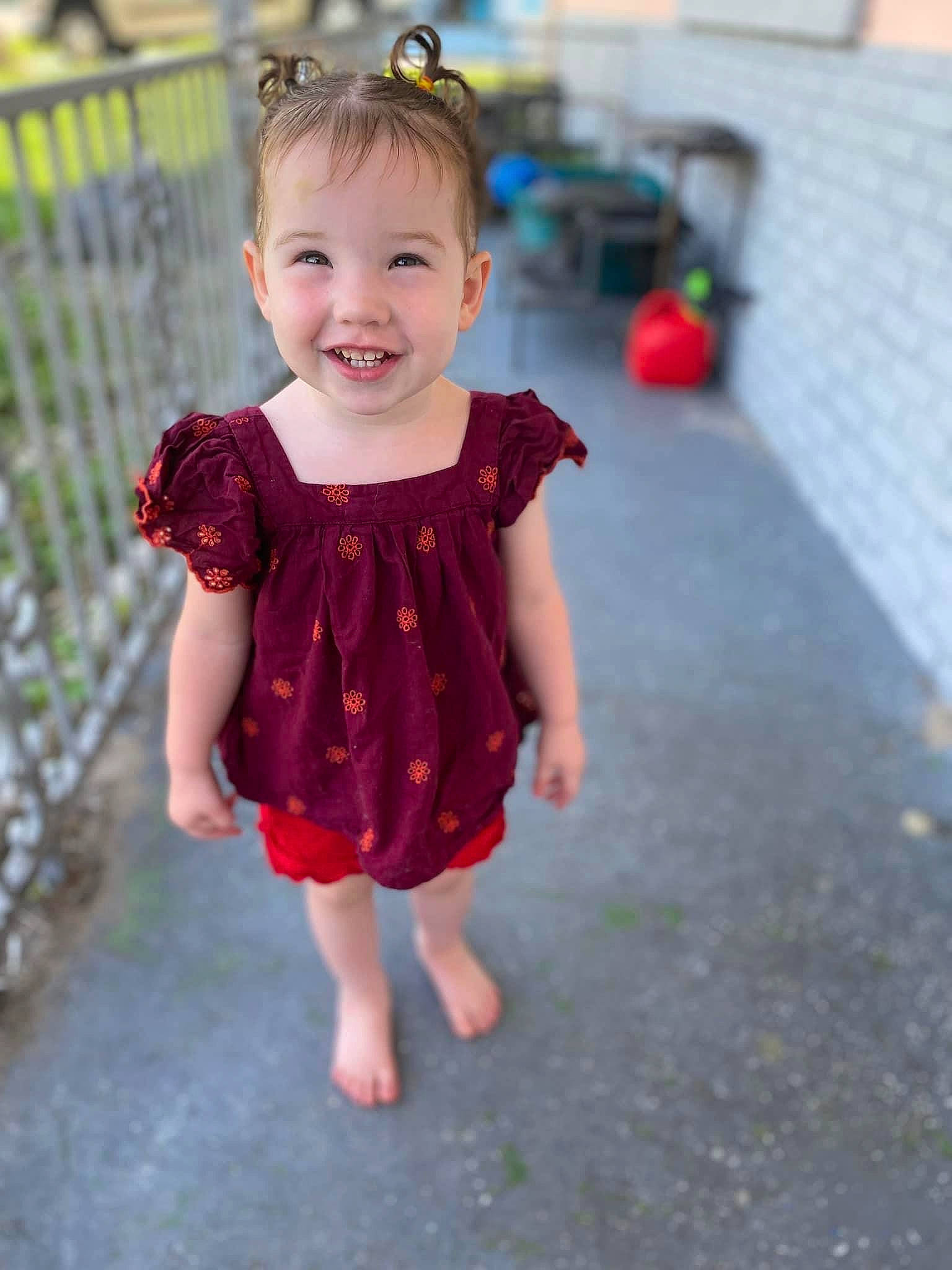 Amethyst is registered to the contest to win money with this photo: baby, baby_toddler_clothing, child, day_dress, dress, face, fence, fun, grass, happy, head, joy, magenta, one_piece_garment, pattern, person, pink, plant, sleeve, smile