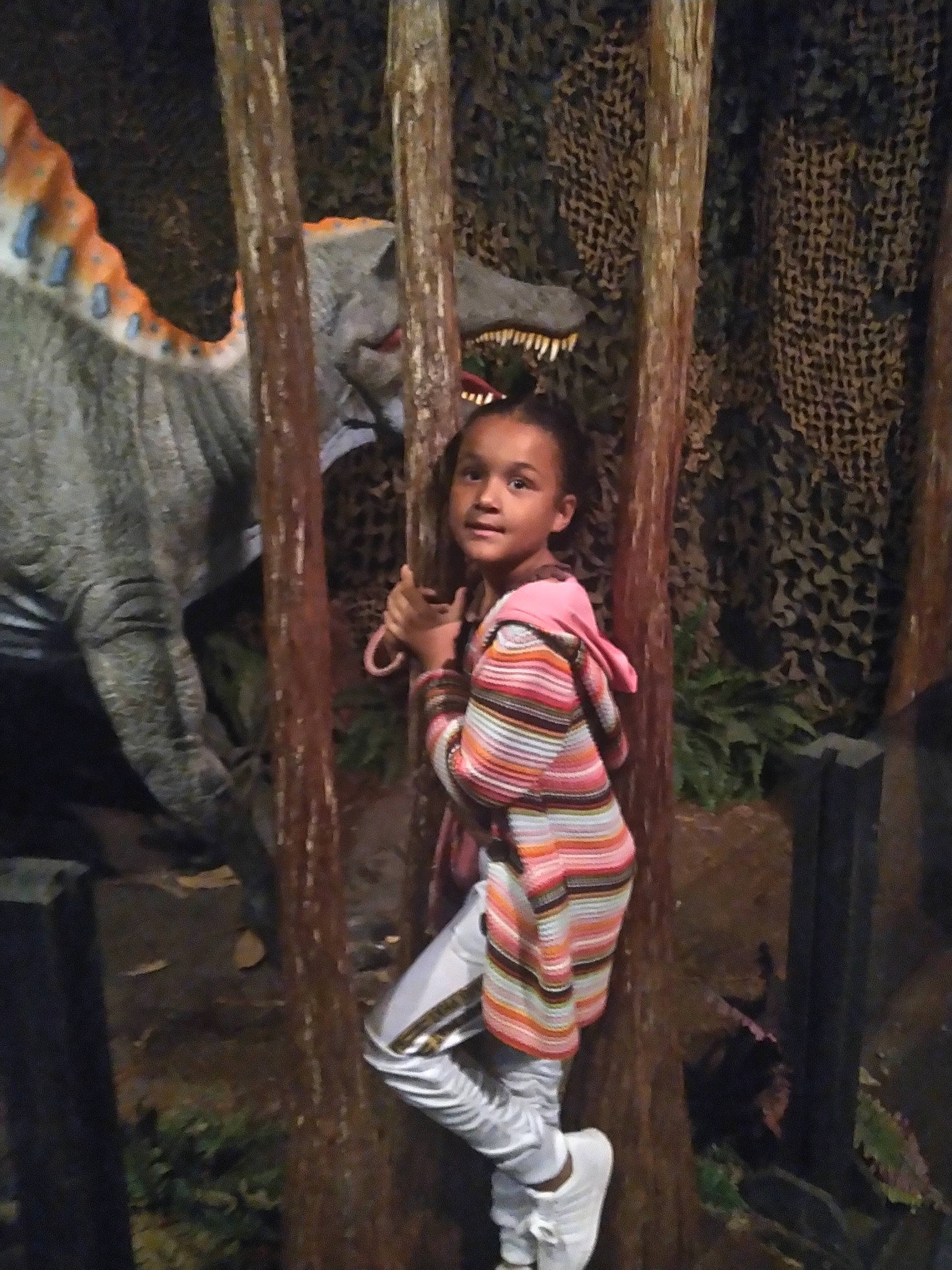 Karissa is registered to the contest to win money with this photo: child, darkness, flash_photography, forest, fun, jungle, leisure, metal, pattern, person, rope, sandal, sitting, soil, temple, toddler, trunk, wood, woodland