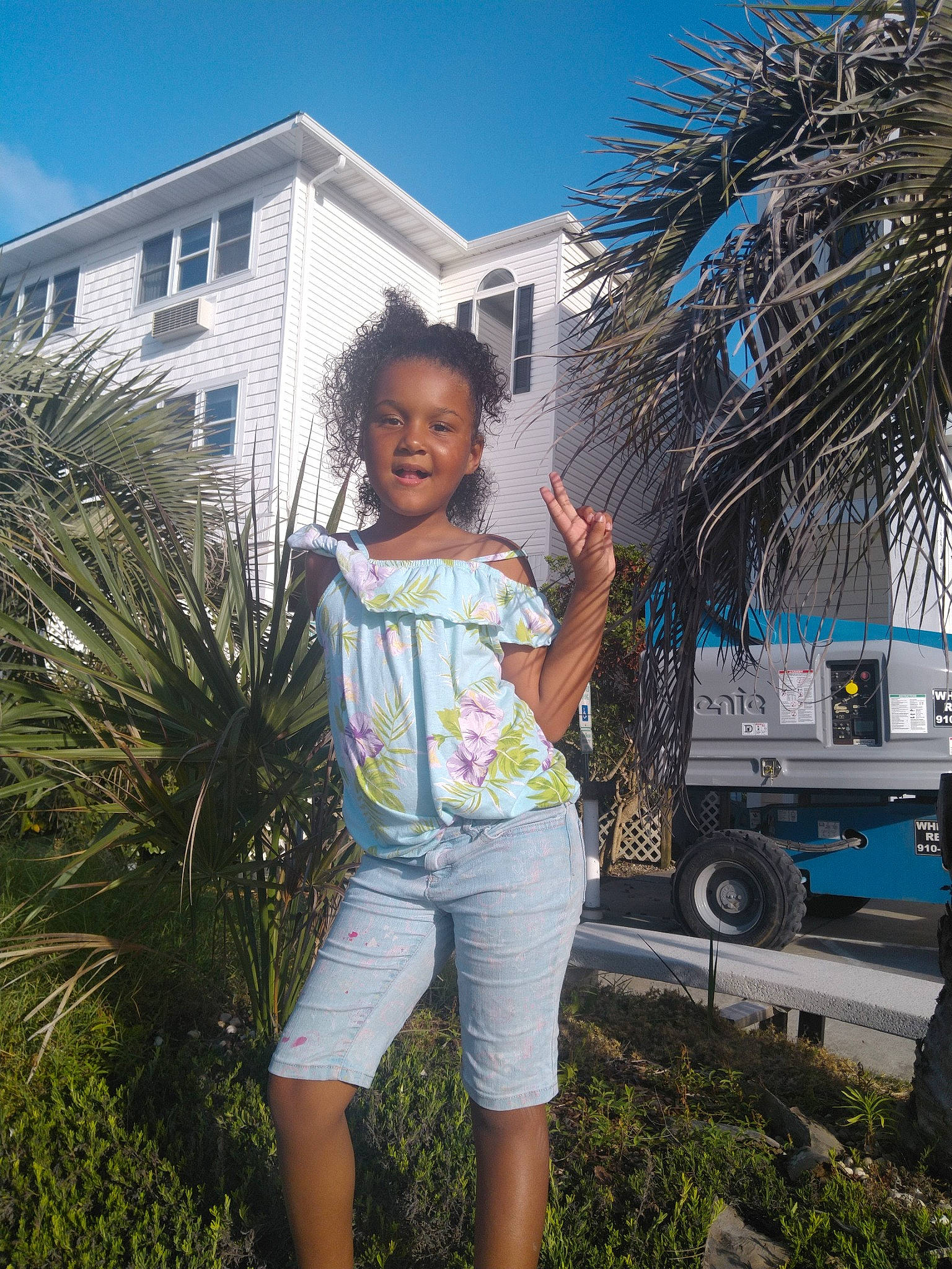 Karissa is registered to the contest to win money with this photo: arecales, building, daytime, electric_blue, fun, grass, happy, house, joy, leisure, people_in_nature, person, plant, sky, smile, thigh, tire, travel, tree, wheel