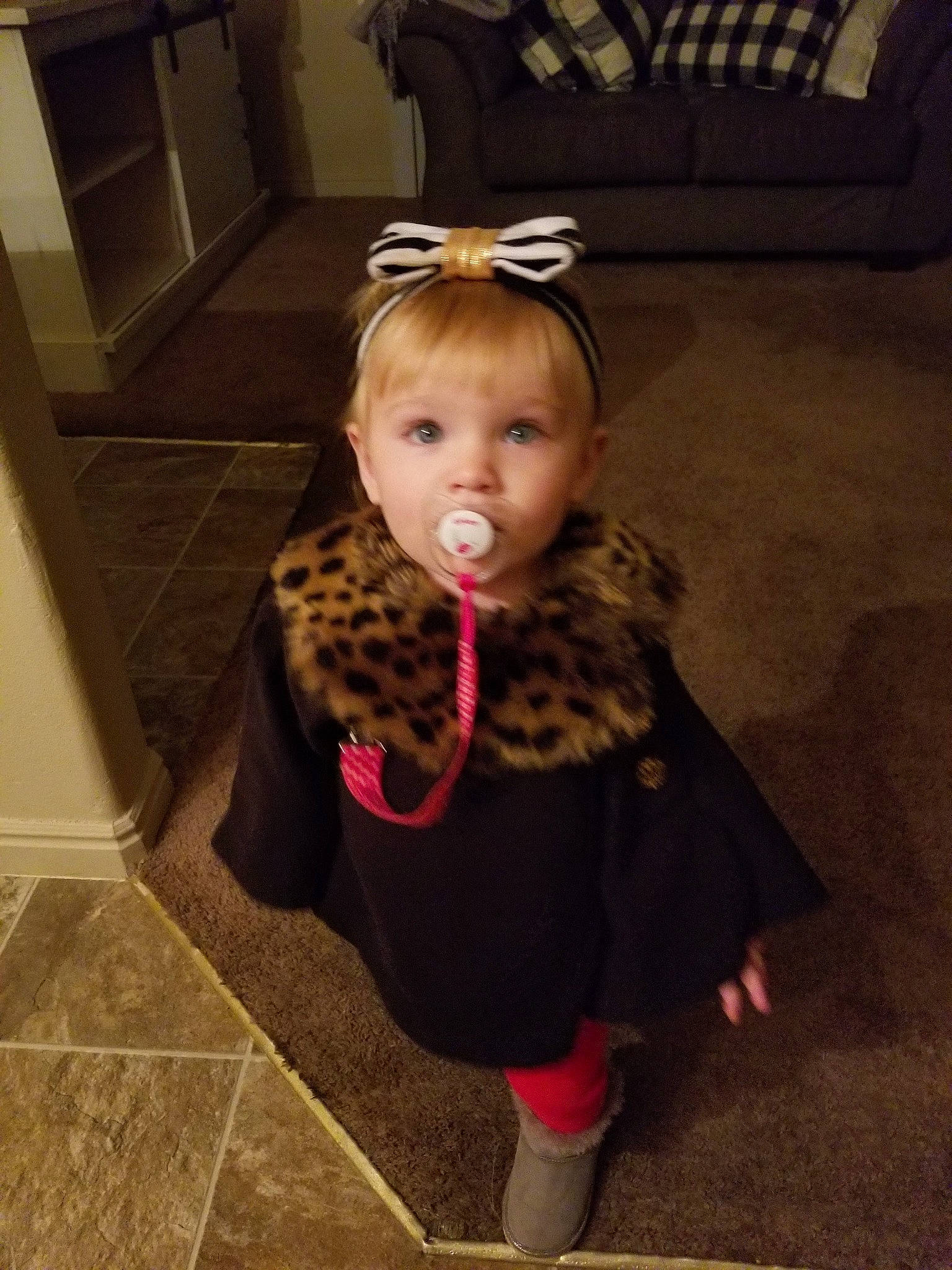 Adaleigh is registered to the contest to win money with this photo: baby, cheek, child, child_model, costume, face, floor, flooring, fur, head, outerwear, person, shoe, skin, toddler