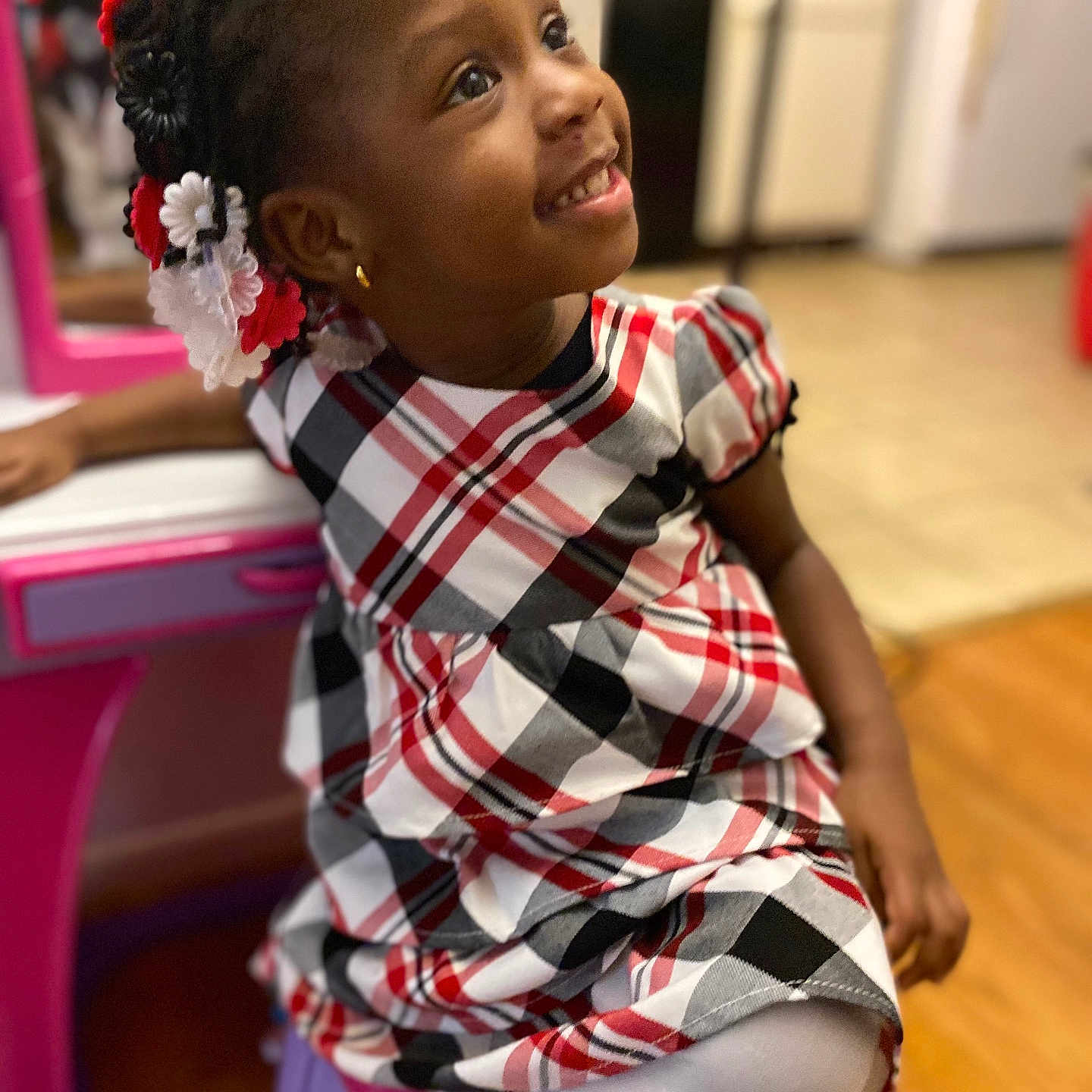 Majouree is registered to the contest to win money with this photo: casual, child, cute, earring, fashion, floor, girl, hair_accessories, happy, home, indoor, plaid_dress, play_desk, portrait, purple_stool, sitting, smiling, toy, wooden_floor, young_child