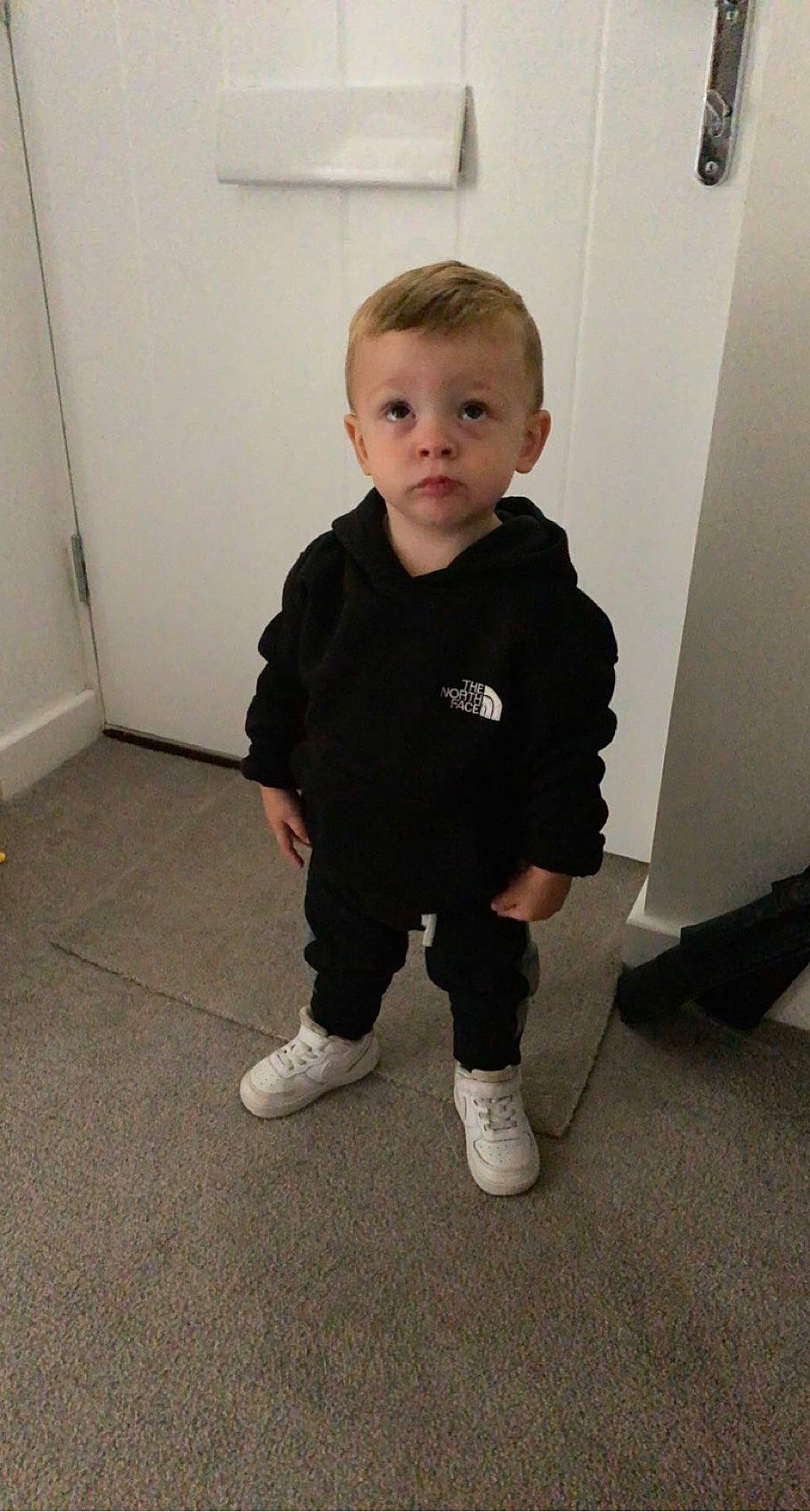 Vinnie is registered to the contest to win money with this photo: baby, baby_toddler_clothing, cheek, child, door, fashion_design, floor, flooring, fun, hardwood, joint, knee, pattern, person, shoulder, sleeve, sock, sweatpant, t_shirt, toddler