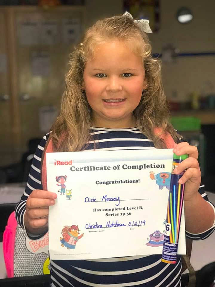 Dixie is registered to the contest to win money with this photo: academic_certificate, academic_institution, award, award_ceremony, blurred, championship, child, competition, competition_event, event, joy, medal, person, recreation, smile, sunglasses, t_shirt, toddler, uniform