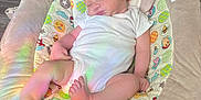 Ezra is registered to the contest to win money with this photo: baby, bed, blanket, clothing, couch, crib, cushion, face, furniture, head, homedecor, infantbed, newborn, person, photography, pillow, portrait, quilt, sleeping, t_shirt