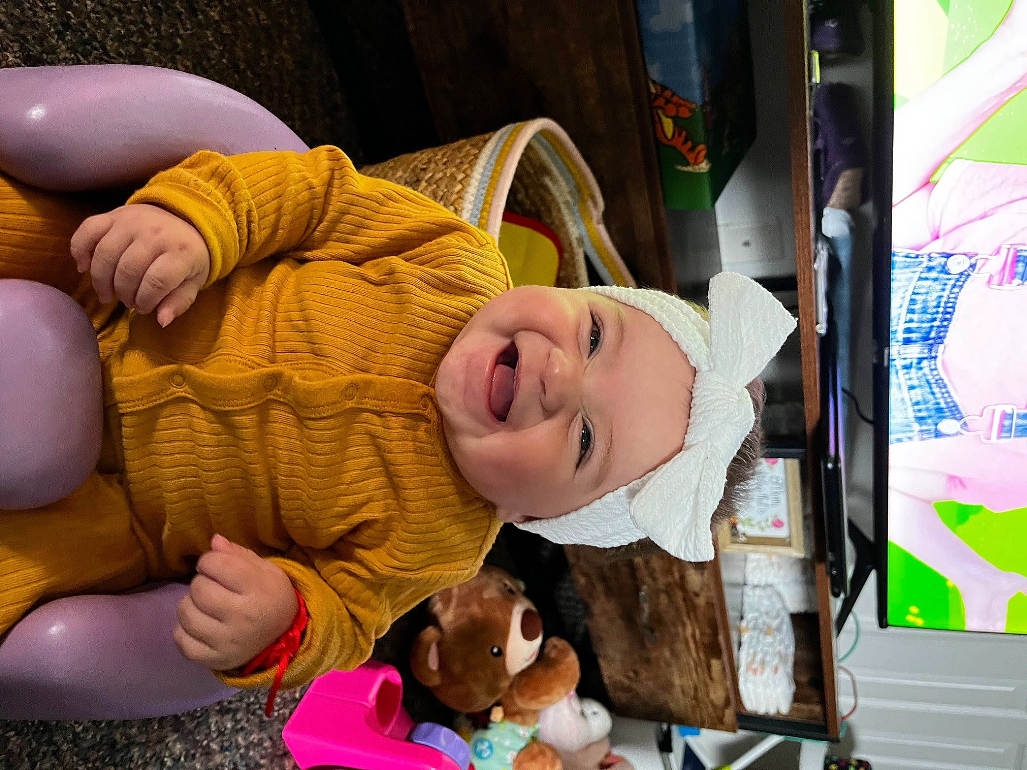 Maria is registered to the contest to win money with this photo: art, baby, baby_laughing, baby_toddler_clothing, child, comfort, event, facial_expression, fun, gesture, happy, hat, headwear, human_leg, joy, leisure, person, product, room, smile