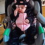 animal, baby, black, child, clothing, costume, cute, expression, face, furniture, hood, indoor, infant, person, pink, playful, seat, soft, stroller, wheel