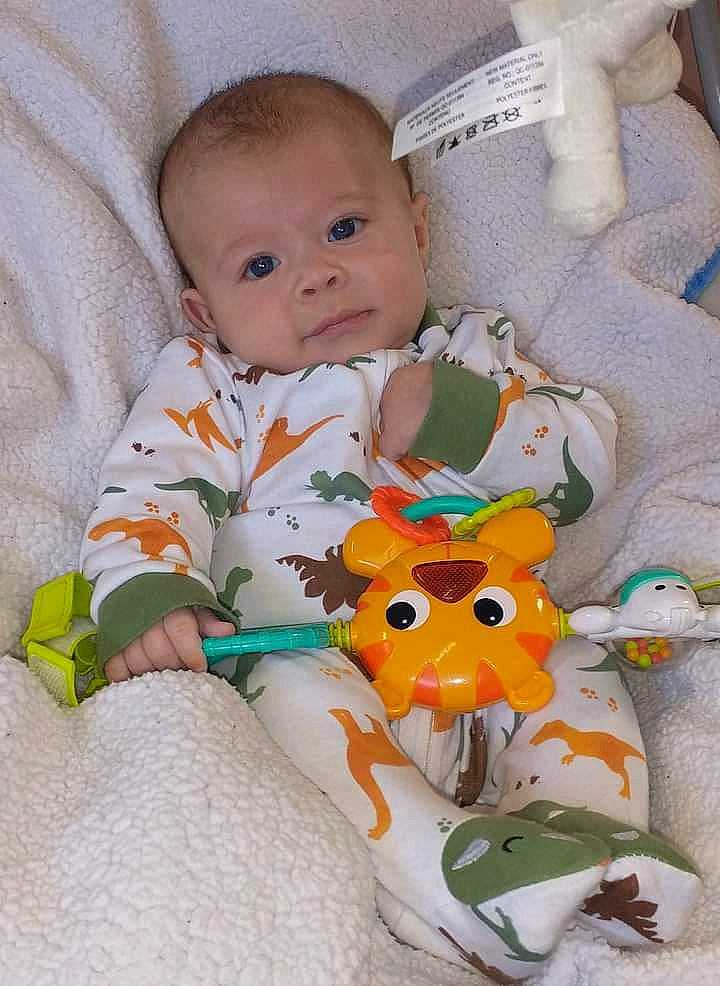 Jerry is registered to the contest to win money with this photo: baby, baby_products, baby_safety, baby_sleeping, baby_toddler_clothing, baby_toys, bedding, cheek, child, comfort, linens, mammal, person, room, sitting, skin, sleeve, stuffed_toy, toddler, toy