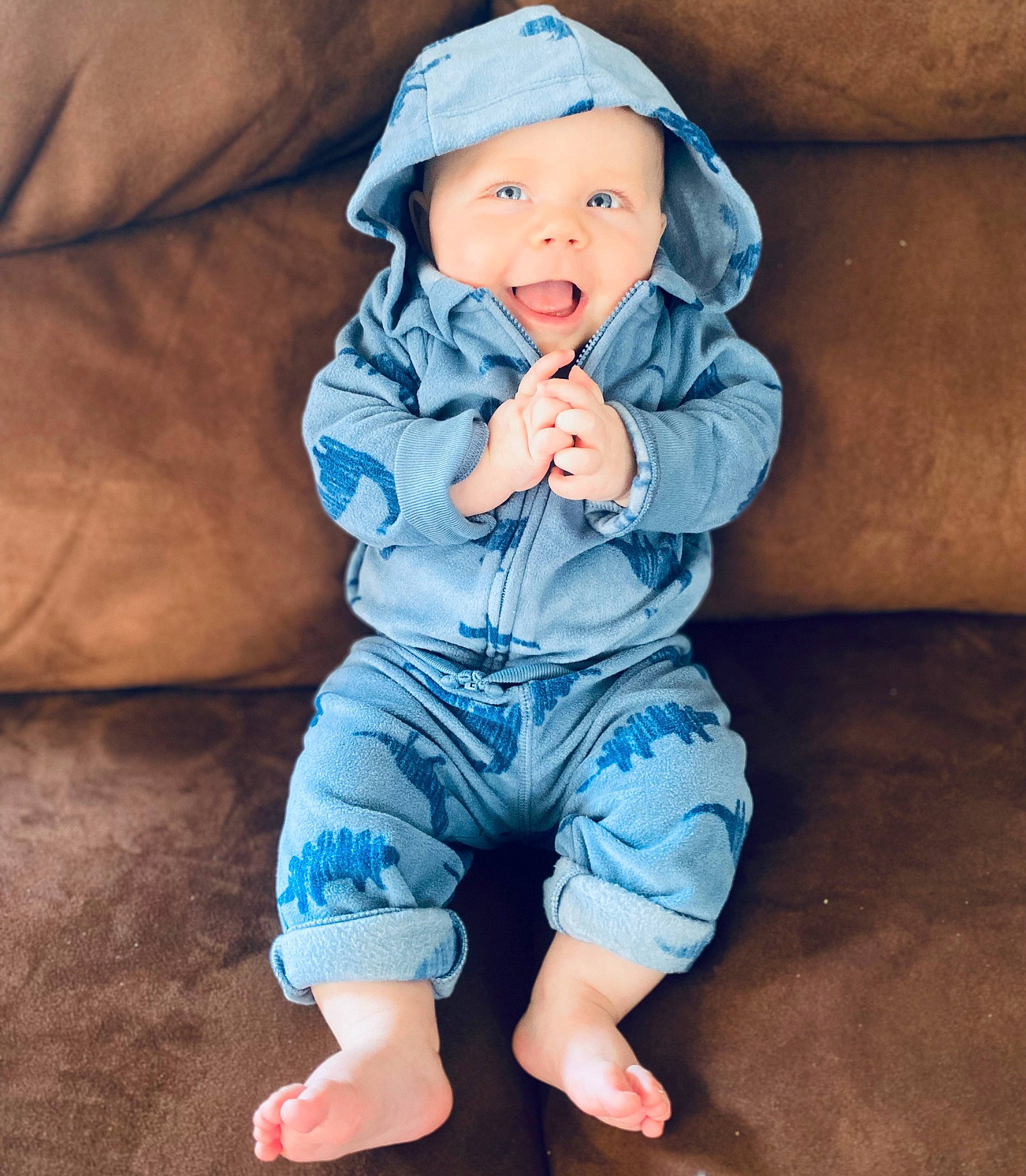 Lawson is registered to the contest to win money with this photo: azure, baby, baby_toddler_clothing, barefoot, blue, child, comfort, couch, denim, electric_blue, eye, happy, headwear, leg, pattern, person, skin, sleeve, smile, t_shirt