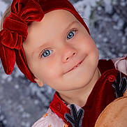 Raven is registered to the contest to win money with this photo: toddler, child, blue_eyes, red_headband, velvet_bow, smiling, face, portrait, holiday_clothing, festive, cute, winter_background, reindeer, button, pink_dress, baby, innocent, young_child, close_up, happy
