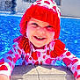 bright_colors, child, cute, face, fun, hands, happy, outdoor, playful, pool, smile, strawberry_pattern, summer, sun_hat, sunlight, swimsuit, toddler, vacation, water, young_child