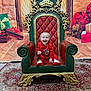 Forrest is registered to the contest to win money with this photo: baby, child, smiling, red_clothing, chair, ornate_chair, holiday, christmas, gift, wrapped_presents, carpet, indoor, decorations, festive, portrait, happy, laughing, floor, background, cute