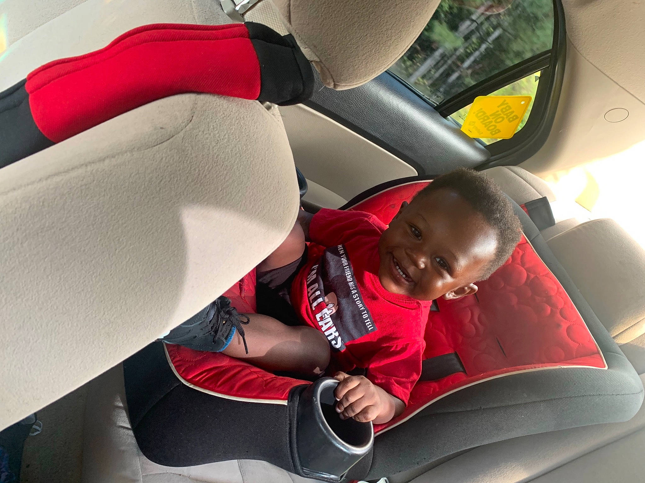 Amarion is registered to the contest to win money with this photo: auto_part, baby_in_car_seat, car, car_seat, car_seat_cover, child, comfort, family_car, joy, lap, leg, person, red, seat_belt, toddler, vacation, vehicle
