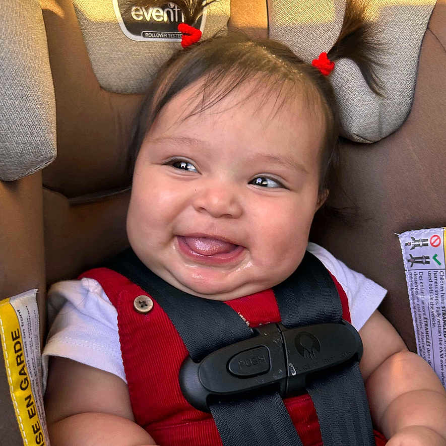 Amelia joined the competition — help win amazing prizes! adorable, baby, bottle, car_seat, child, child_safety, cute, face, hands, happy, indoors, infant, person, pigtails, portrait, red_clothing, seat_belt, skin, smiling, young