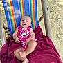 baby, smiling, beach_chair, rainbow_stripes, pink_swimsuit, minnie_mouse, towel, sand, outdoor, sunny, child, happy, infant, relaxing, summer, barefoot, cute, vacation, playful, portrait