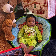 Yasser joined the competition — help win amazing prizes! baby, chair, child, christmas, cute, decorations, face, festive, floor, gift_box, green_clothing, happy, holiday, indoor, person, plush_toy, present, red_ribbon, smiling, teddy_bear