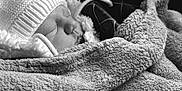 Isaac a rejoint le concours — aidez-le/la à gagner de superbes lots ! baby, infant, sleeping, blanket, hat, beanie, hood, fur_trim, cozy, soft_texture, closeup, portrait, monochrome, black_and_white, newborn, resting, face, head, fabric, peaceful