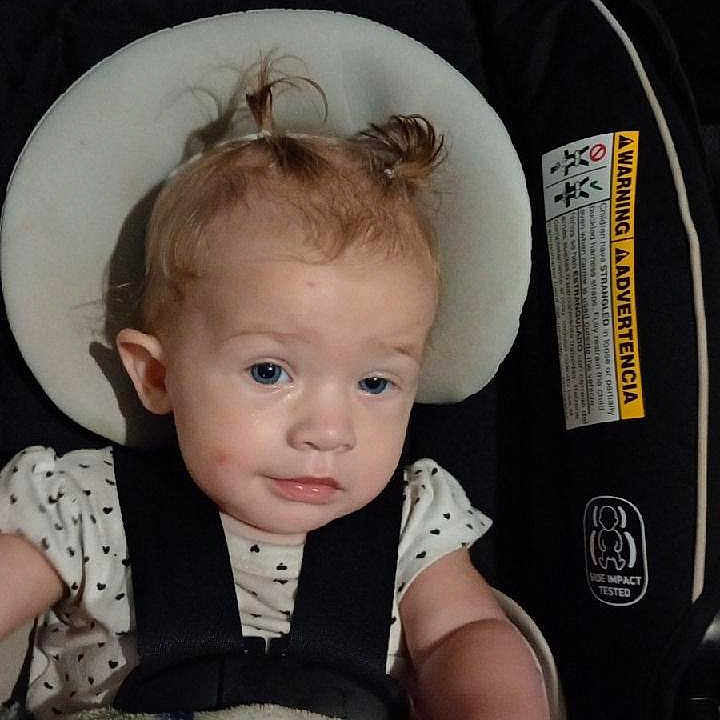 Sianna joined the competition — help win amazing prizes! baby, blanket, car_seat, child, clothing, cute, expression, face, hair, headrest, indoor, infant, person, pigtails, portrait, seat, sitting, straps, toddler, young