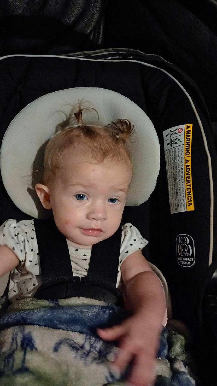 Sianna joined the competition — help win amazing prizes! toddler, child, car_seat, blanket, hair, pigtails, face, straps, clothing, indoor, baby, seat, expression, person, portrait, infant, cute, young, sitting, headrest