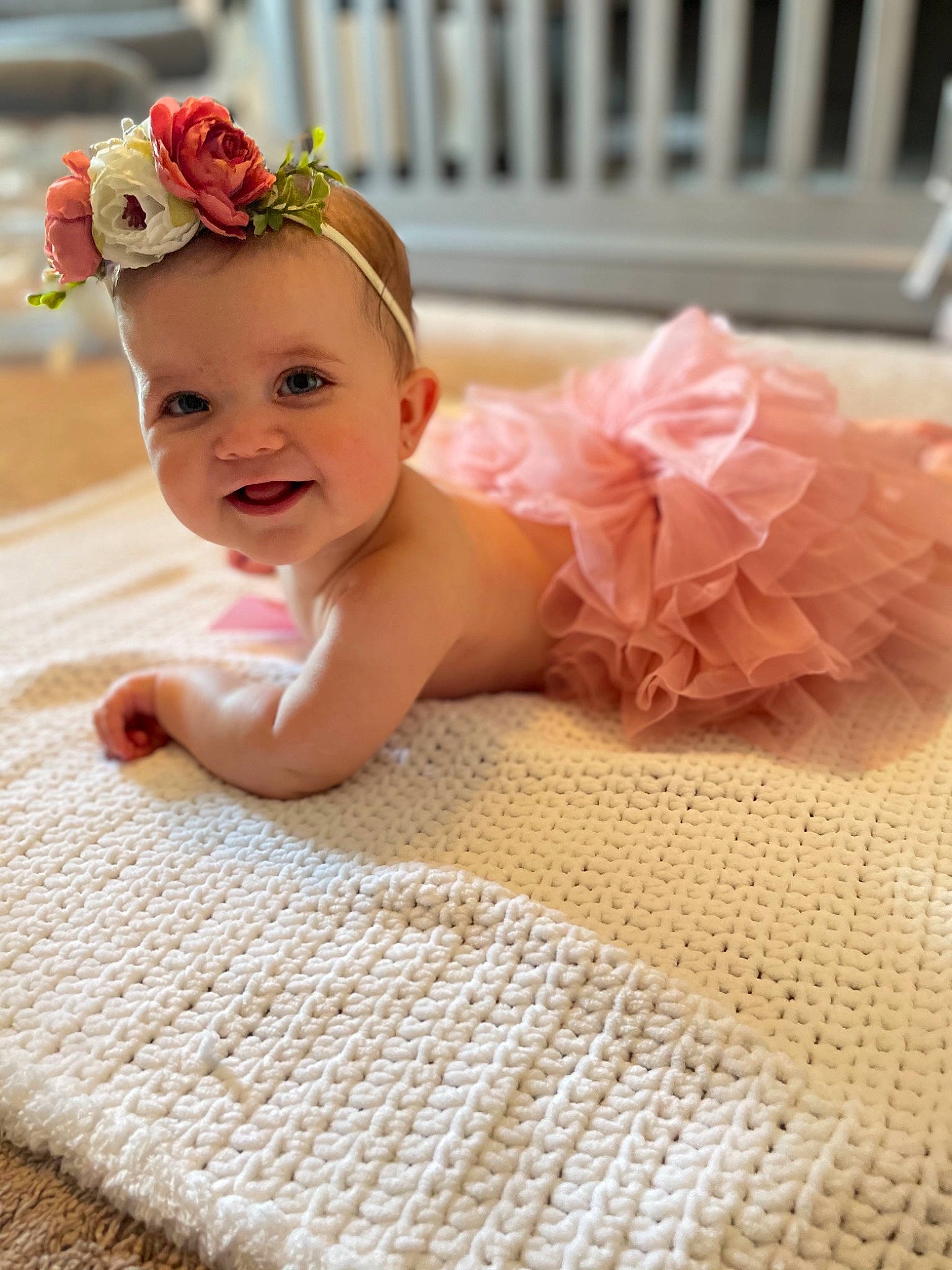 Olivia joined the competition — help win amazing prizes! baby, baby_toddler_clothing, child, comfort, dress, finger, flooring, flower, happy, headband, headgear, headpiece, iris, person, petal, pink, plant, skin, smile, textile