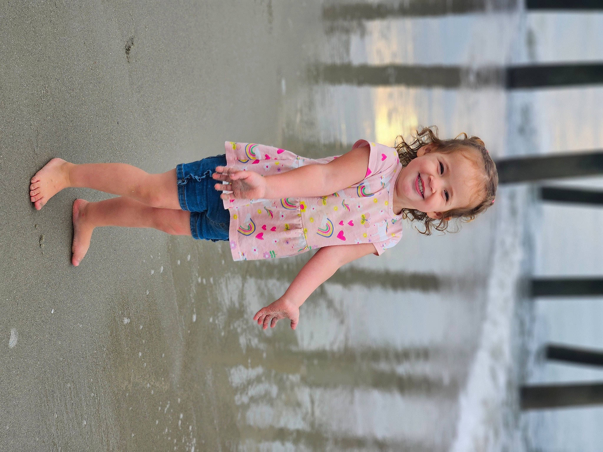 Emerie is registered to the contest to win money with this photo: baby, baby_toddler_clothing, barefoot, child, dress, fun, happy, human_leg, joy, leg, leisure, pattern, people_in_nature, person, recreation, shorts, skin, smile, standing, thigh